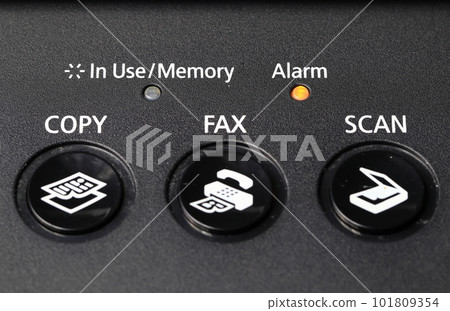 close up of Multifunction facsimile or fax keypad with yellow alarm light. 101809354