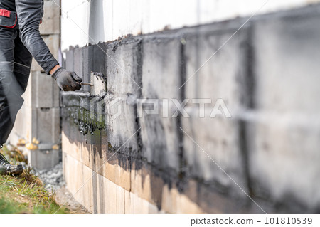 waterproofing of the wall with a covered asphalt belt during the construction of the building 101810539