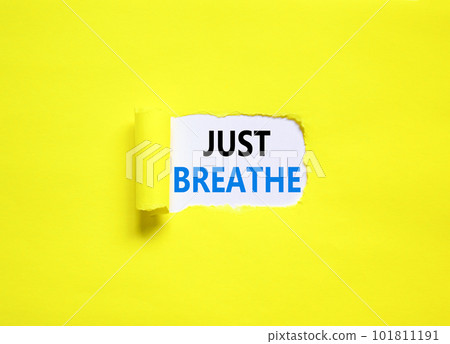 Just breathe and psychological symbol. Concept words Just breathe on beautiful white paper. Beautiful yellow table yellow background. Business psychological and Just breathe concept. Copy space 101811191