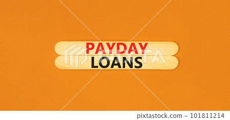Payday loans symbol. Concept words Payday loans on beautiful wooden stick. Beautiful orange table orange background. Business and Payday loans concept. Copy space. 101811214
