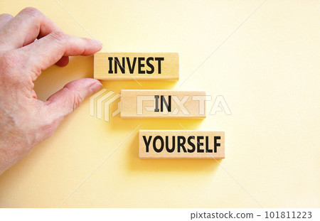 Invest in yourself symbol. Concept words Invest in yourself on wooden block on a beautiful white table white background. Businessman hand. Business and Invest in yourself concept. Copy space. 101811223