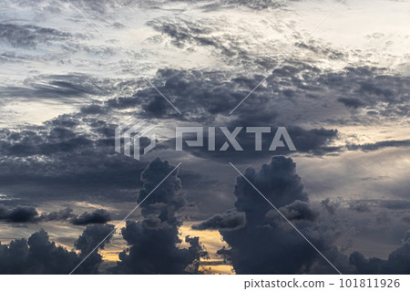 Dark clouds obscure a colorful sunset. 101811926