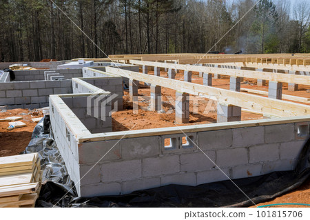 Cement blocks laid wall for foundation of house on construction site. 101815706