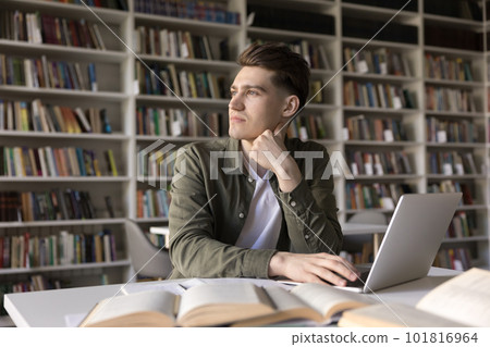 Pensive focused student guy preparing for session in library Pensive focused student guy preparing for session in library 101816964