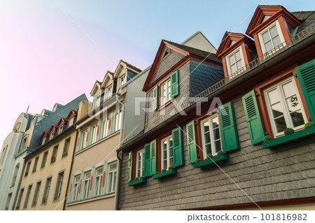 European windows with green wooden shutters in old house. Outdoors exterior European windows with green wooden shutters in old house. Outdoors exterior 101816982