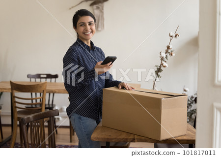 Satisfied Indian woman sending parcel using courier on-line services Satisfied Indian woman sending parcel using courier on-line services 101817011