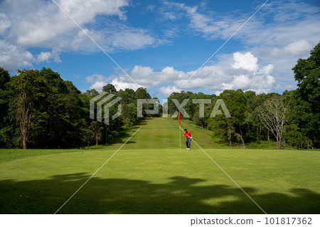 Blurred Golfer putting ball on the green golf, lens flare on sun set evening time Blurred Golfer putting ball on the green golf, lens flare on sun set evening time 101817362