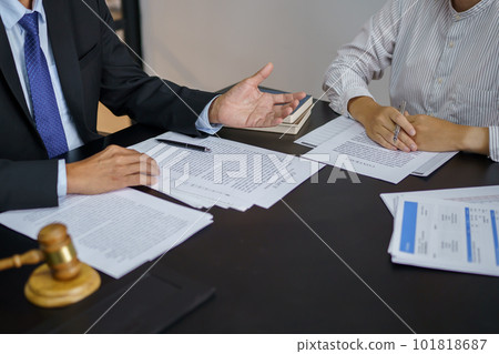 Lawyer Legal counsel presents to the client a signed contract with gavel and legal law. justice and lawyer Business partnership meeting concept. Lawyer Legal counsel presents to the client a signed contract with gavel and legal law. justice and lawyer Business partnership meeting concept. 101818687
