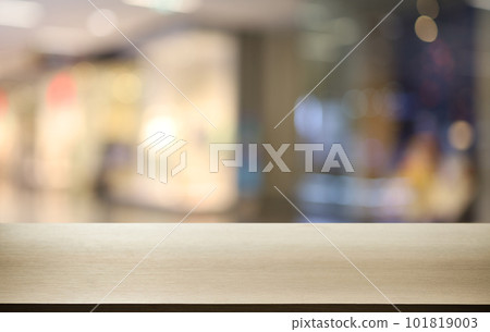 Empty wooden table in front of abstract blurred background of coffee shop . can be used for display or montage your products.Mock up for display of product 101819003
