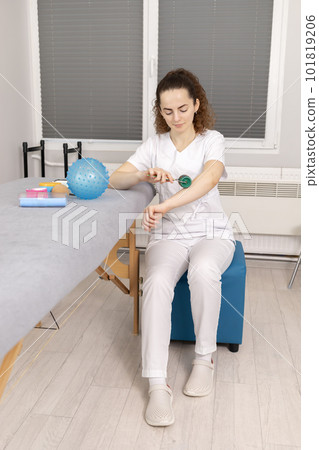 Rehabilitation Specialist, Physical Therapist With Rehab Tools, Foam Roller,Massage Ball With Pimples, Mesoroller With Titanium Needles, Kinesiology Tape On Couch in Therapeutic Room. Vertical plane. Rehabilitation Specialist, Physical Therapist With Rehab Tools, Foam Roller,Massage Ball With Pimples, Mesoroller With Titanium Needles, Kinesiology Tape On Couch in Therapeutic Room. Vertical plane. 101819206