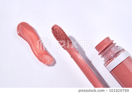 Red lip gloss with applicator and smear. Red lip gloss with applicator and smear. 101820789