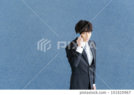 Photo of a young office worker with a smartphone 101820967