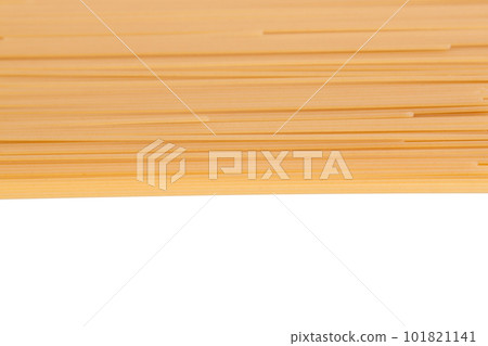 Spaghetti spread out on a white surface. 101821141