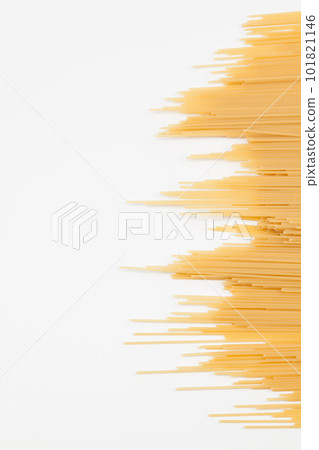 Spaghetti spread out on a white surface. 101821146