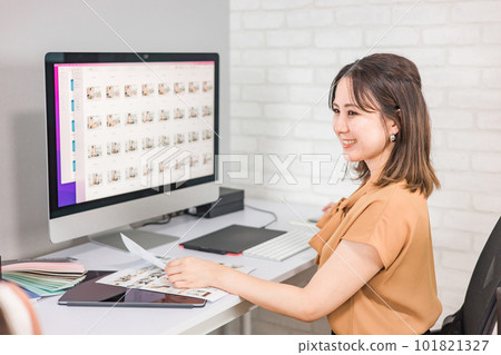 A woman who works as a photo editor, image editor, photo processor, retoucher, and graphic designer 101821327