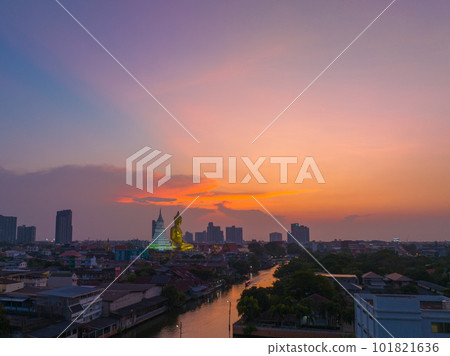 aerial view golden big Buddha Wat Paknam Phasi Charoen in sunset.  beautiful sunset reflection on a canal in front big buddha.  scenery sky in twilight background.the one famous landmarks in Thailand. 101821636