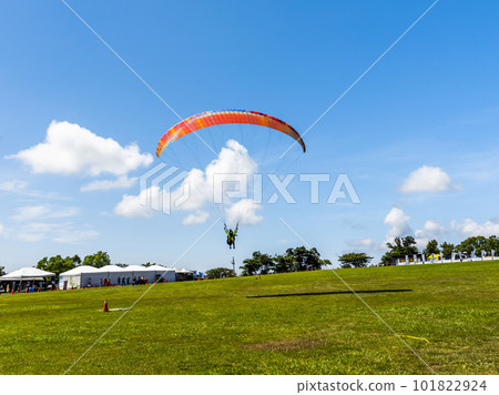Paragliding extreme Sport with blue Sky and clouds in the background, at Luye highland in Taitung, Taiwan. 101822924