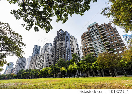 Low-angle view of green park space and modern buildings on both sides in downtown Taichung, Taiwan. here is near the National Taichung Theater. 101822935