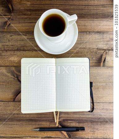 Coffee in a cup, notebook and pen. Vertical photo. 101825539