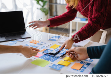 Creative team web designer planning application development for web mobile phone at modern workplace. Creative team web designer planning application development for web mobile phone at modern workplace. 101828076