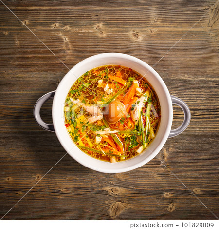 Rooster soup with smoked quail egg 101829009