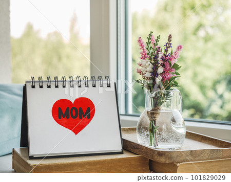 Notepad with the word MOM. Closeup, indoors 101829029
