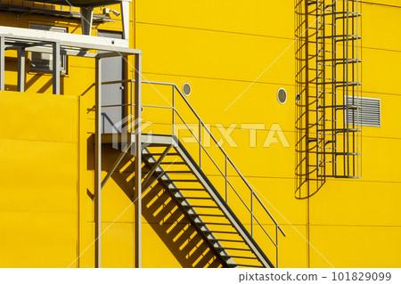 Fire escape stairs mounted to the outside 101829099