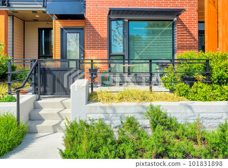 Small patio with BBQ in front of private entrance to a residential unit Small patio with BBQ in front of private entrance to a residential unit 101831898