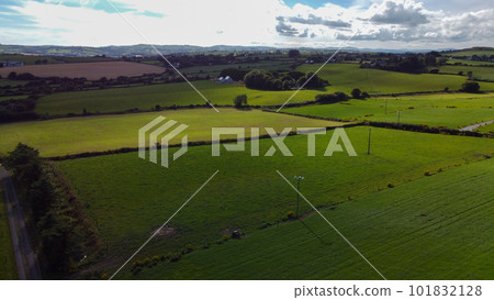 Green farm fields separated by shrubs, top view. Cattle pastures in the south of Ireland. Agricultural landscape, nature. Green grass 101832128