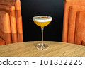 Summer cocktail garnished with passion fruit. rich yellow cold beverage on bar terrace. 101832225