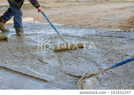 Workers used various tools to ensure proper leveling of poured concrete. Workers used various tools to ensure proper leveling of poured concrete. 101832247