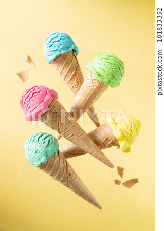 Flying colorful ice cream scoops in cones, bright background. Levitation Flying colorful ice cream scoops in cones, bright background. Levitation 101833352