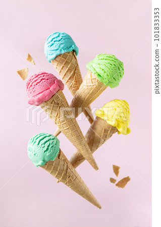 Flying colorful ice cream scoops in cones, bright background. Levitation 101833353