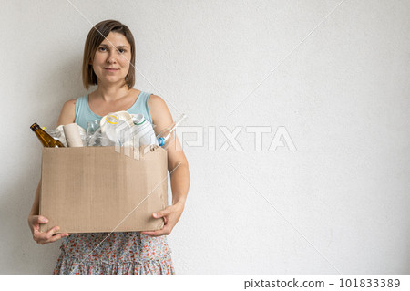 Female holding box of recycling materials, white background 101833389