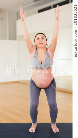 Pregnant woman is engaged in yoga. Chair Pose or Utkaasana 101833621