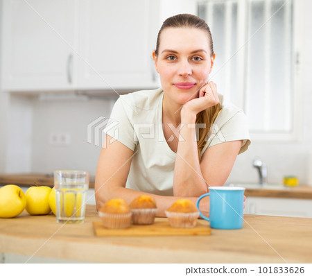 Positive woman having breakfast, drinking coffee Positive woman having breakfast, drinking coffee 101833626