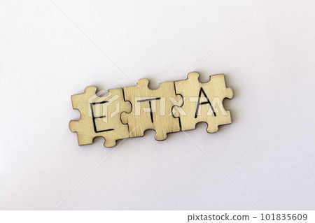 The acronym ETA, which stands for Estimated Time of Arrival. The letters written on the puzzles. 101835609