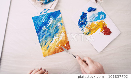 Finish artwork. Female artist. Creative studio. Unrecognizable woman creating abstract picture on canvas with spatula. Finish artwork. Female artist. Creative studio. Unrecognizable woman creating abstract picture on canvas with spatula. 101837792