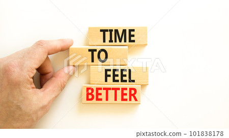 Time to feel better symbol. Concept words Time to feel better on wooden block. Beautiful white table white background. Businessman hand. Motivational business time to feel better concept. Copy space Time to feel better symbol. Concept words Time to feel better on wooden block. Beautiful white table white background. Businessman hand. Motivational business time to feel better concept. Copy space 101838178