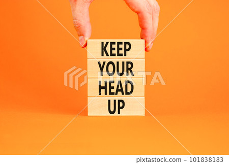 Keep your head up symbol. Concept words Keep your head up on wooden cubes. Beautiful orange table orange background. Businessman hand. Business motivational keep your head up concept. Copy space. 101838183