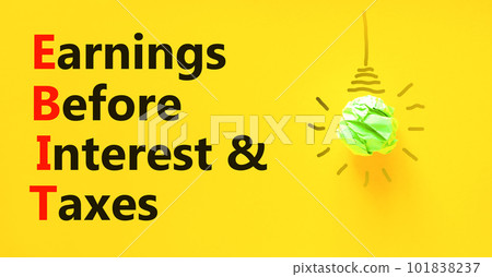 EBIT symbol. Concept words EBIT earnings before interest and taxes on yellow paper beautiful yellow background. Light bulb icon. Business EBIT earnings before interest and taxes concept. Copy space. 101838237