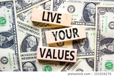 Live your values symbol. Concept words Live your values on wooden blocks. Dollar bills. Beautiful background from dollar bills. Business, psychological and live your values concept. Copy space. Live your values symbol. Concept words Live your values on wooden blocks. Dollar bills. Beautiful background from dollar bills. Business, psychological and live your values concept. Copy space. 101838278