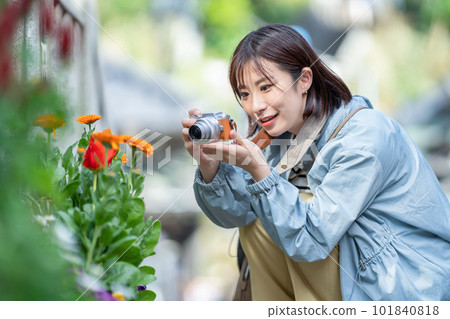 A woman traveling A woman taking pictures in a tourist spot A woman enjoying sightseeing A woman strolling in a tourist spot 101840818