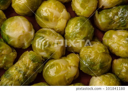 Delicious boiled Brussels sprouts on a ceramic plate on a dark concrete background 101841180