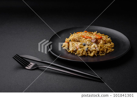 Delicious Uzbek pilaf with chicken, carrots, barberry, spices and herbs 101841301