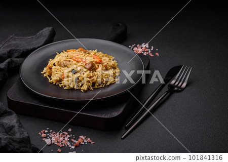 Delicious Uzbek pilaf with chicken, carrots, barberry, spices and herbs Delicious Uzbek pilaf with chicken, carrots, barberry, spices and herbs 101841316