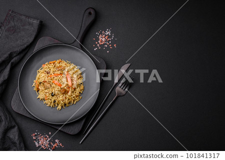 Delicious Uzbek pilaf with chicken, carrots, barberry, spices and herbs Delicious Uzbek pilaf with chicken, carrots, barberry, spices and herbs 101841317