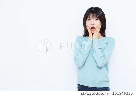 A woman in her thirties who is surprised in front of a white background A woman in her thirties who is surprised in front of a white background 101846336