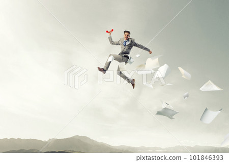 Portrait of energetic businessman jumping in open air 101846393