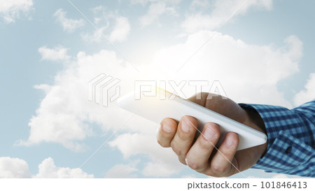 Hand with a smartphone on background Hand with a smartphone on background 101846413